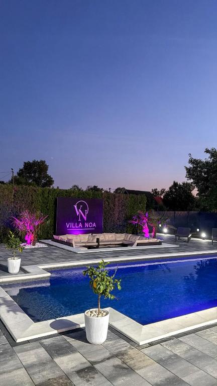 a swimming pool with a sign that says villa zoo at Villa NOA in Bijeljina