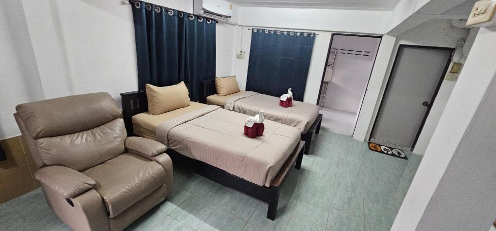a room with two beds and a couch and a chair at Ao Nang Room And Bike 10 in Ao Nang 