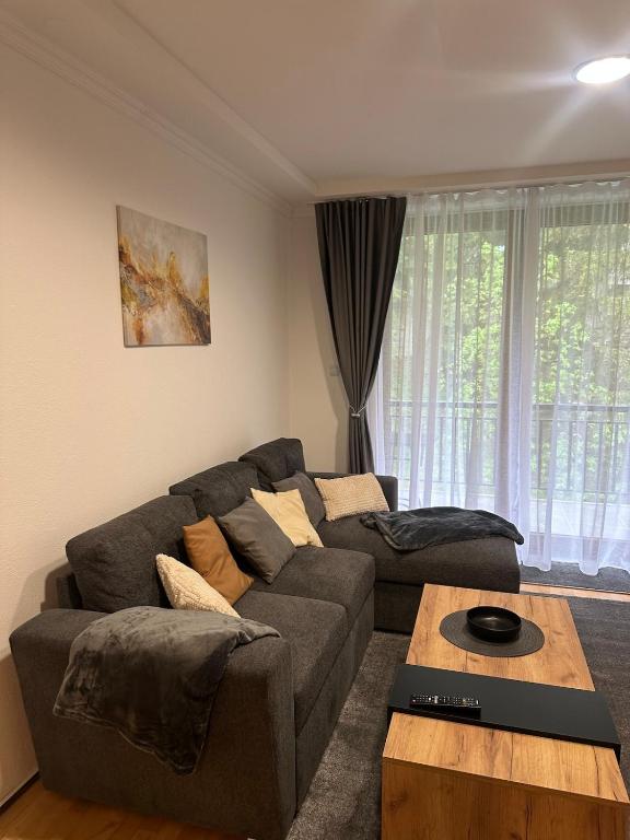 a living room with a couch and a coffee table at Monteluce Apartment Vlašić in Šišava