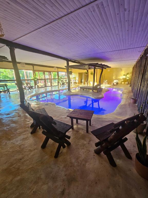 a pool with benches and a table in a building at La Maina Uribe in Uribelarrea