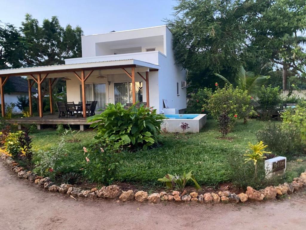 a small house with a hot tub in the yard at Shiri Beach Resort in Zanzibar City