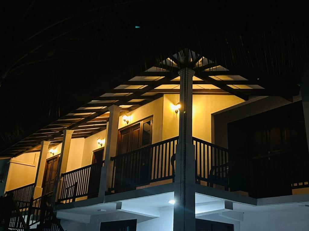 a balcony of a house at night with lights at Wagon Inns anuradhapura in Anuradhapura