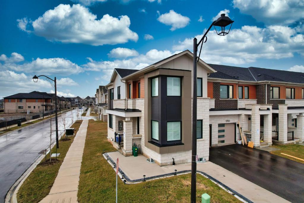 a row of houses on a street with a street light at Smart & Cute 1BR Basement Apartment-Milton in Milton