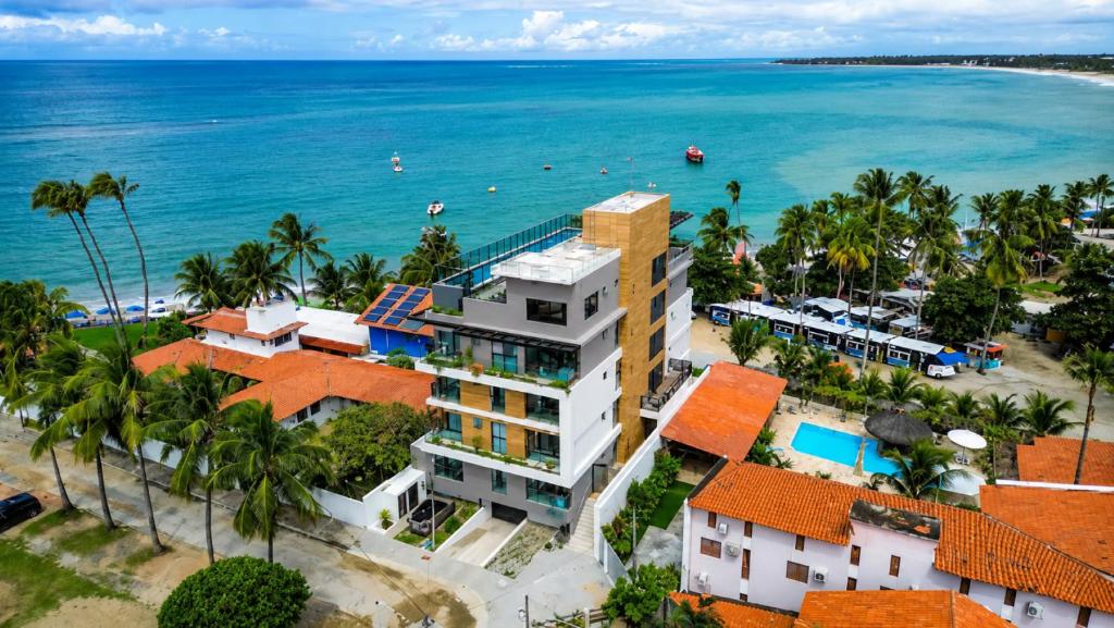 an aerial view of the resort and the ocean at Beachfront flat at Porto de Galinhas beach, close to the natural pools. in Porto De Galinhas