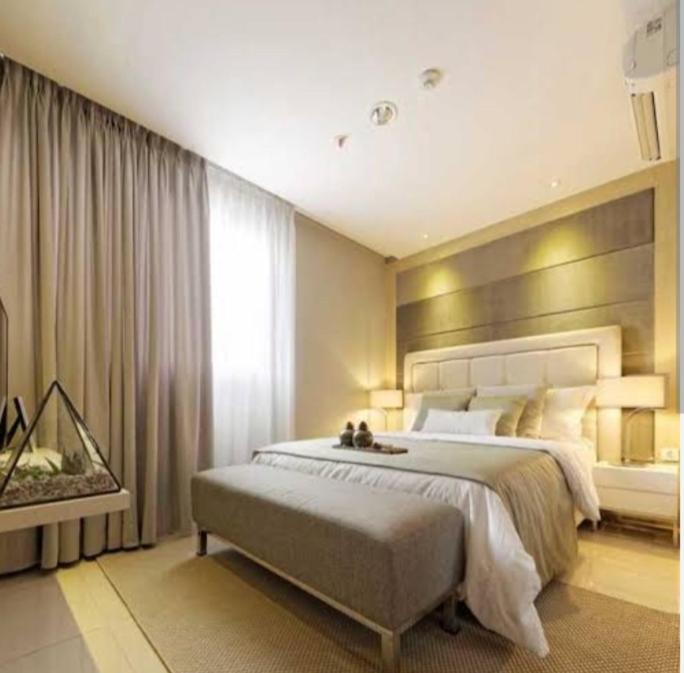a bedroom with a large bed and a window at villa house luxury in Cianjur