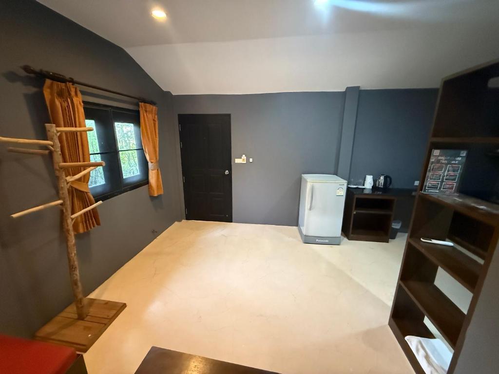an empty kitchen with a refrigerator in a room at KT Garden Villa in Ko Samui