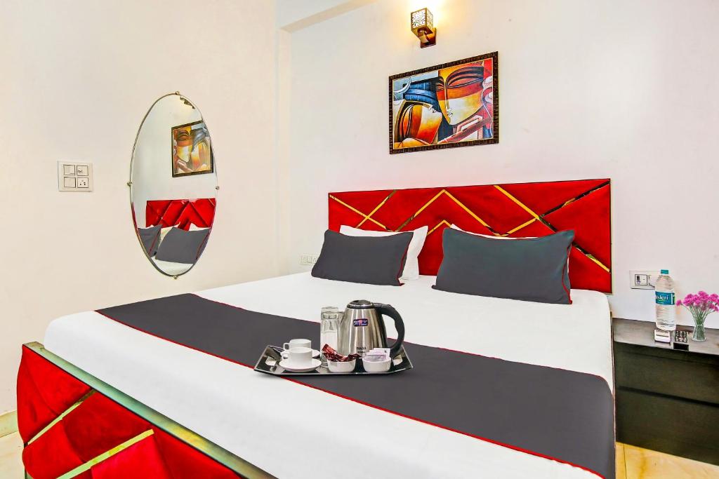 a hotel room with a bed and a mirror at Hotel O Ethereal Inn in New Delhi
