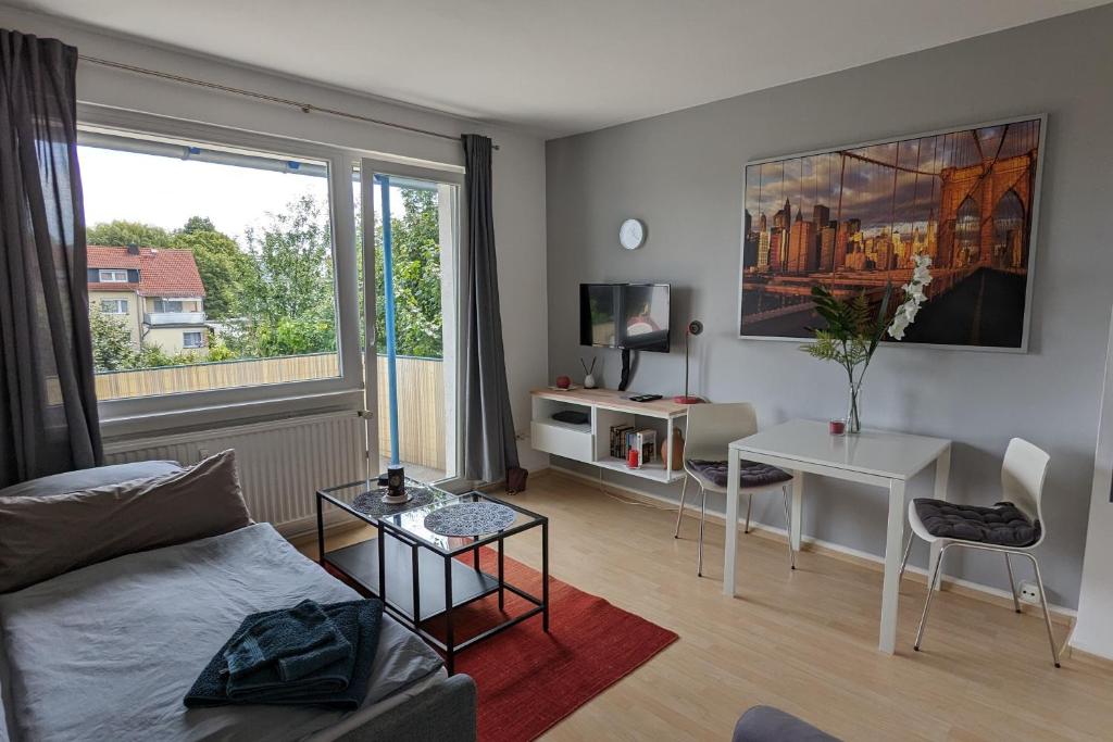 a living room with a couch and a table at Ferienwohnung Bad Vilbel in Bad Vilbel