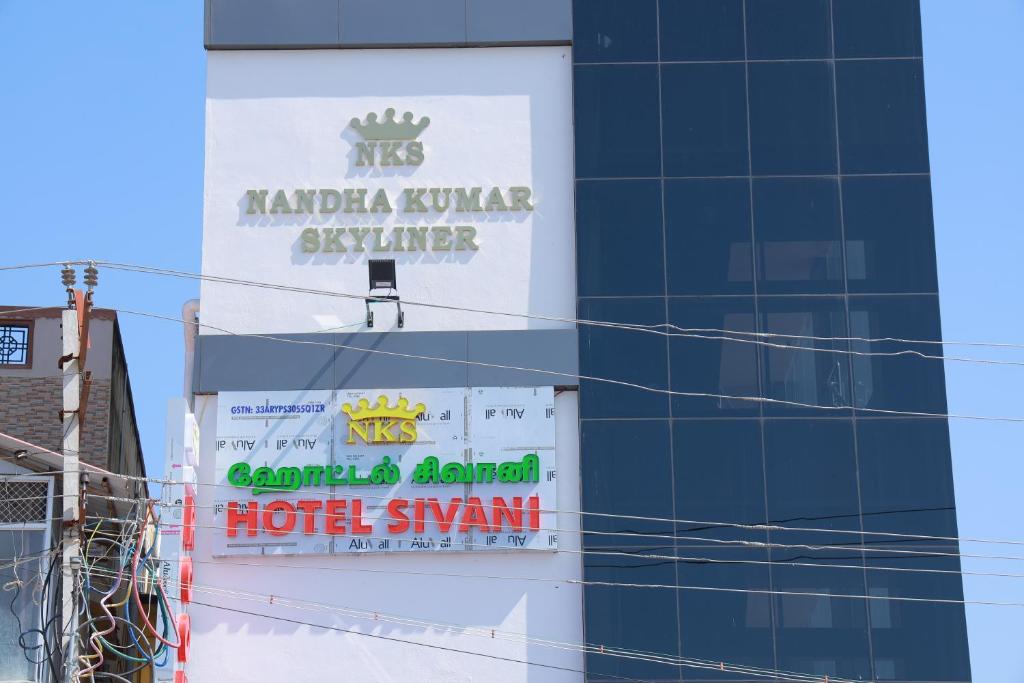 a building with a hotel sign on the side of it at Hotel Sivani in Kalakkādu