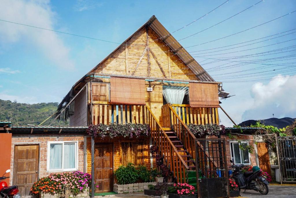 a house with a staircase in front of it at Sameer Mountain View Cottage in Tanah Rata