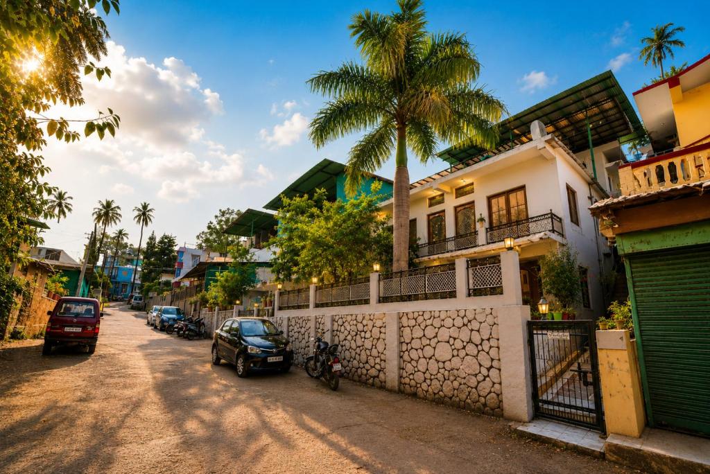 a street with a house and a palm tree at Peach stay in Mount Ābu