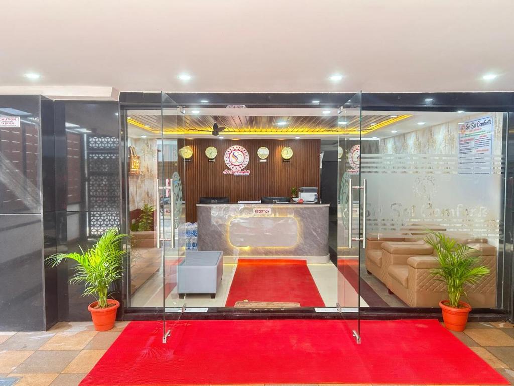 a room with a red carpet and a red rug at Sri Sai Comforts Manyata Tech Park in Bangalore