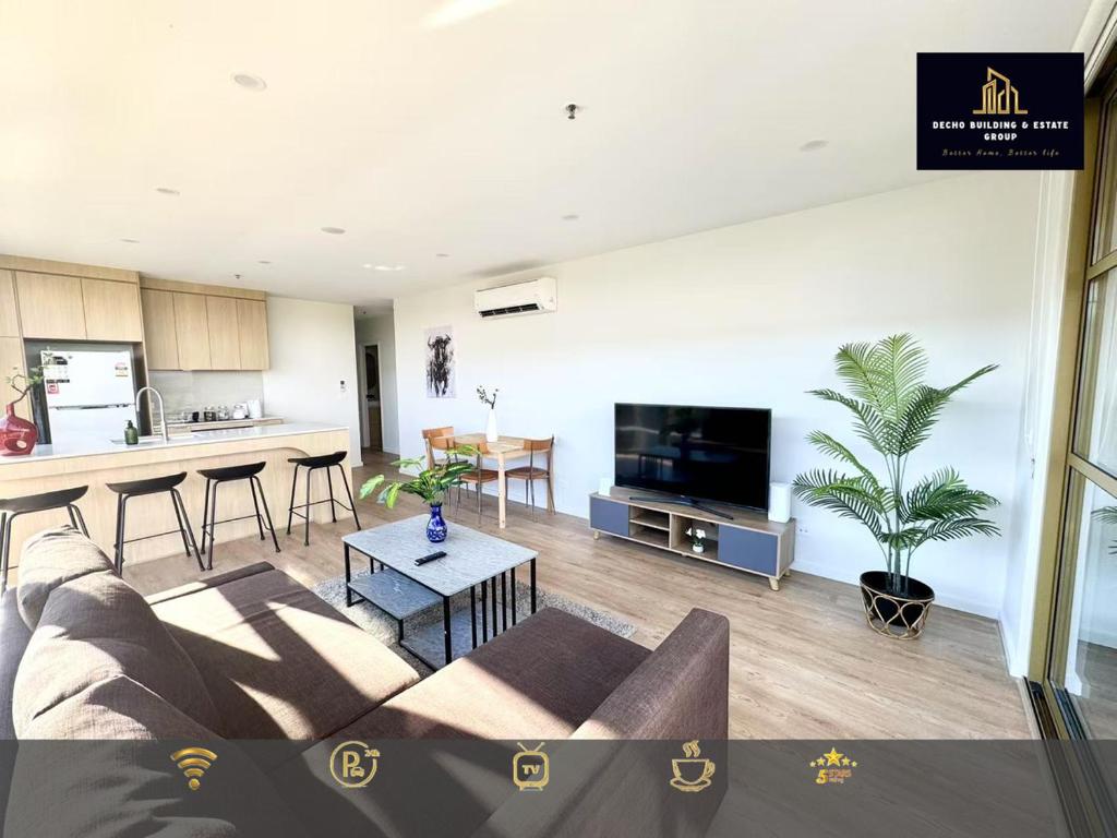 a living room with a couch and a kitchen at C04-Summerfield Stylish 2BR Apart, Mountain view in Weston Creek