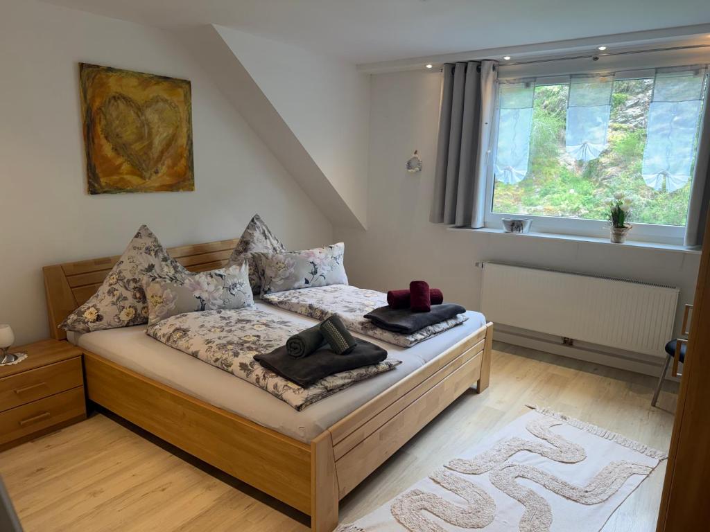 a bedroom with a bed with two towels on it at DeNi's Ferienwohnungen in Klotten