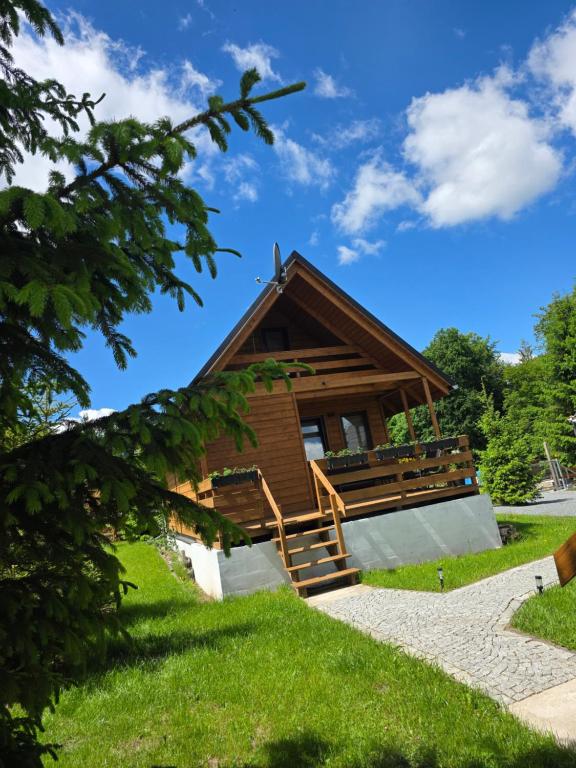 a log cabin with a staircase leading up to it at Klimatyczne drewniane Domki Jagodna Spalona 6D-2 jacuzzi sauna,trasy rowerowe in Spalona