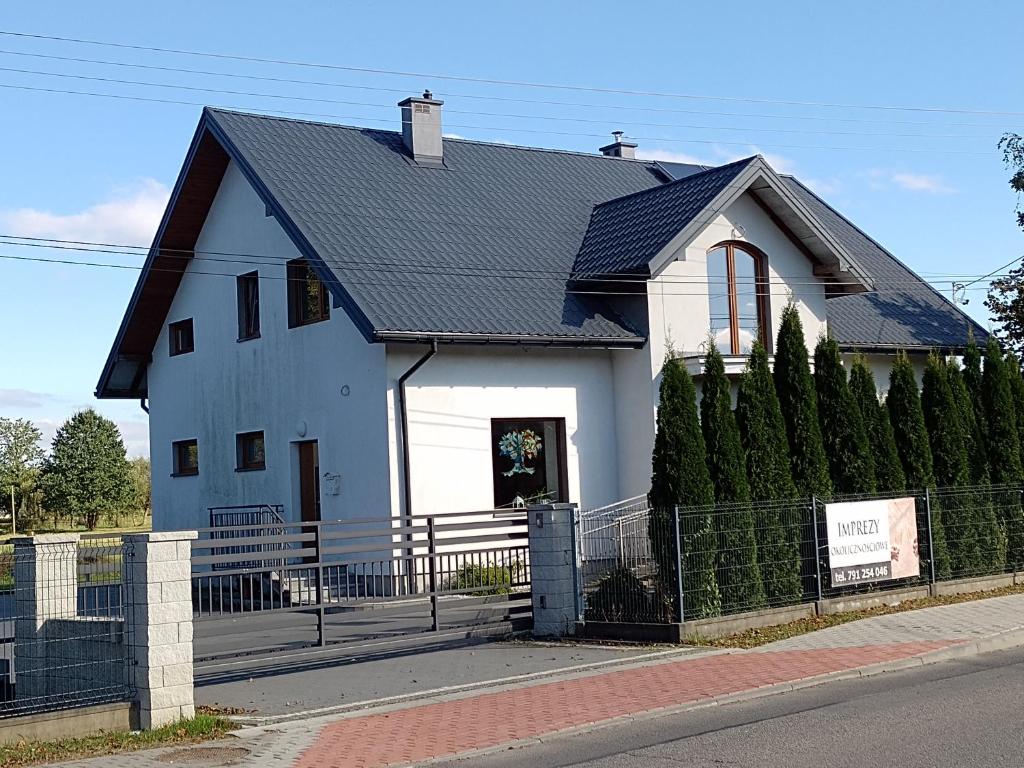 a white house with a black roof at Spełnienie Marzeń Bóbrka in Bóbrka