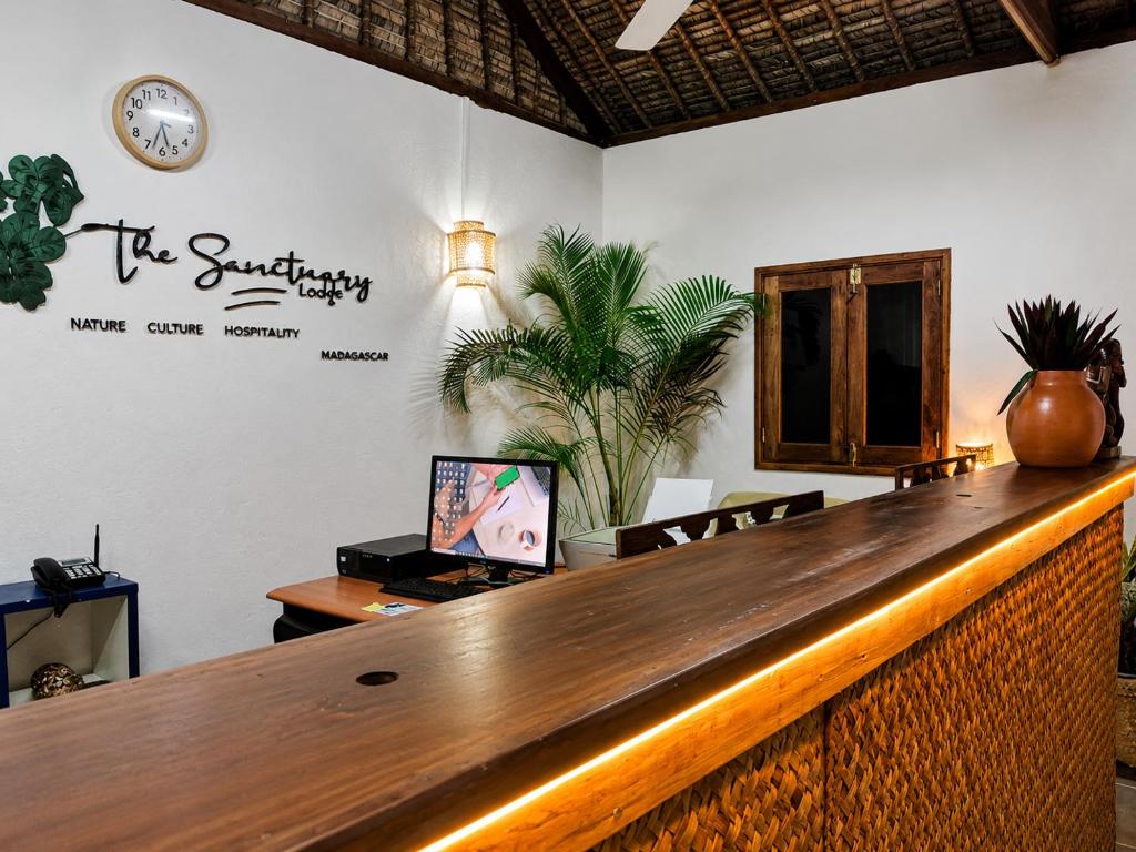 a bar in a restaurant with a sign on the wall at The Sanctuary MADAGASCAR in Foulpointe