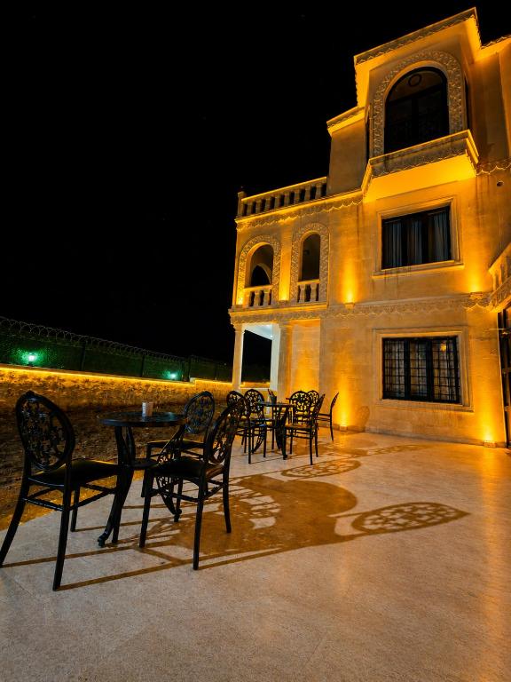 a group of tables and chairs in front of a building at Kasr-ı Cihan Boutique Hotel in Midyat