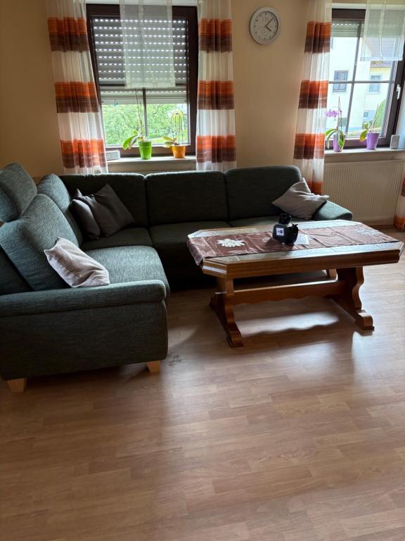 a living room with a couch and a coffee table at Uller`s Ferienwohnung im Usseltal in Daiting