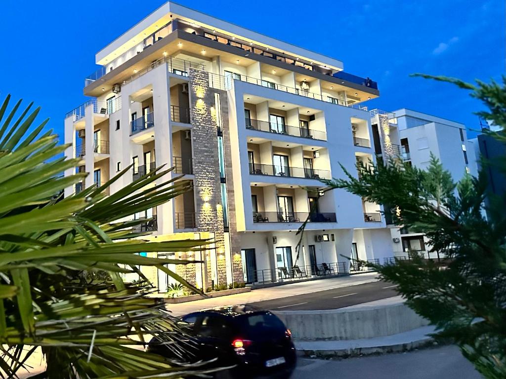 a building with a car parked in front of it at SUPREME Luxury in Ulcinj