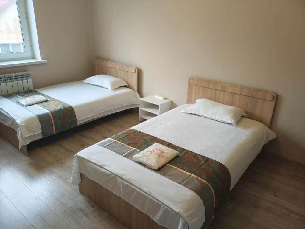 a bedroom with two beds and a window at Minsu in Mamyr