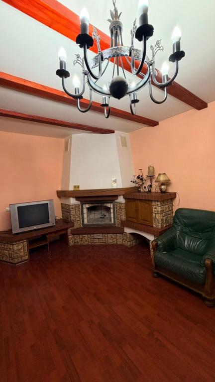 a living room with a fireplace and a chandelier at Стара Прага in Uzhhorod