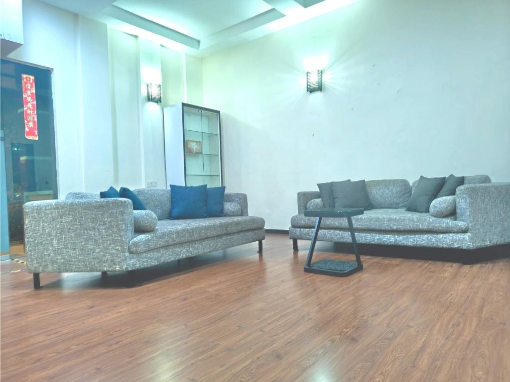 two couches and a table in a room at Windsor Lane Hostel Ipoh in Ipoh