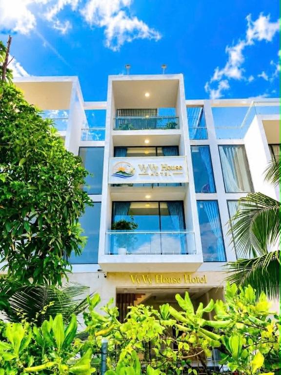 a white building with a sign on it at VyVy House Hotel in Tuy Hoa