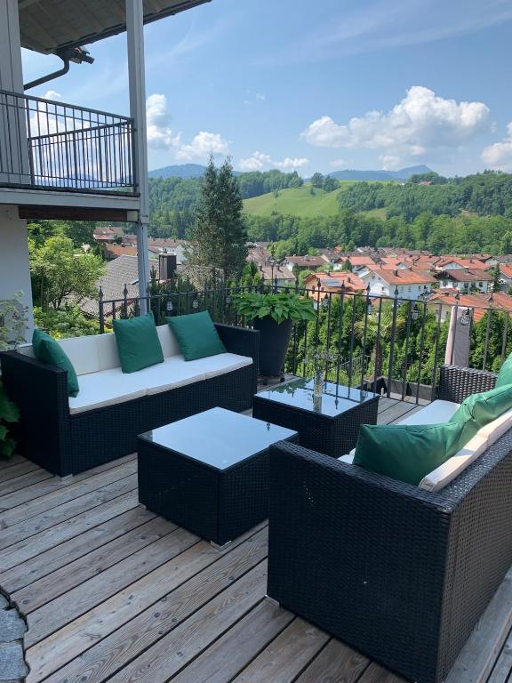 a patio with couches and tables on a deck at Chalet im Chiemgau in Siegsdorf