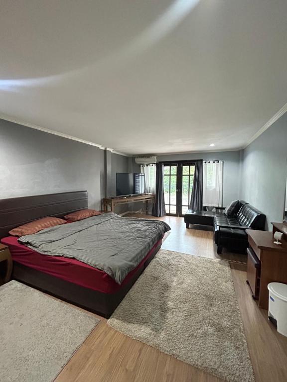 a bedroom with a large bed and a living room at My Dream Wedding in Nathon Bay