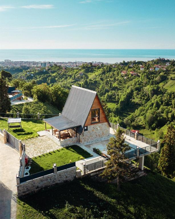 a house on a hill with a roof at Koda Bungalov in Ardeşen