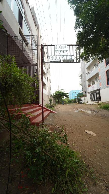 a gate to a building with a sign on it at Hotel good vibes in Coimbatore