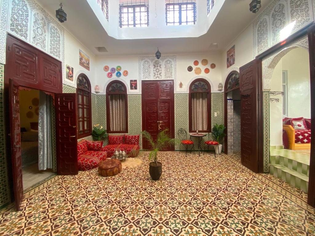 a living room with red furniture in a room at Dar Nassiri in Rabat