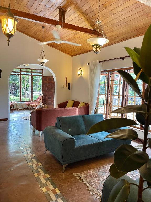 a living room with a blue couch in a room at Kandy Living Homestay in Kandy