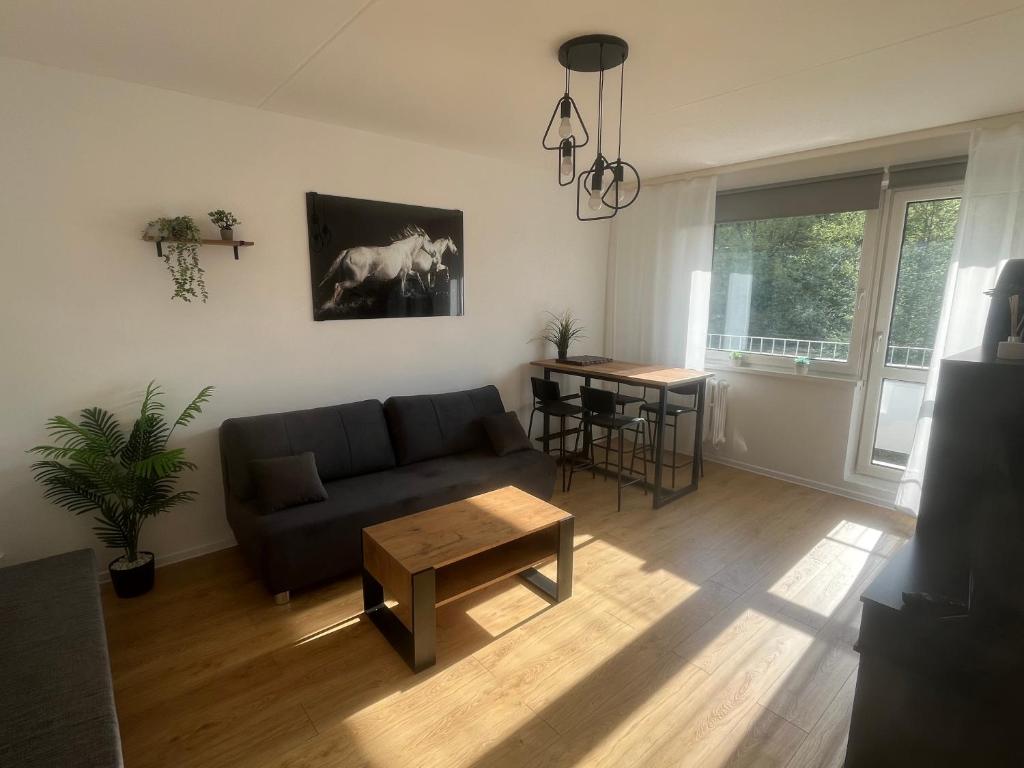 a living room with a couch and a table at Apartament Nati in Cieszyn