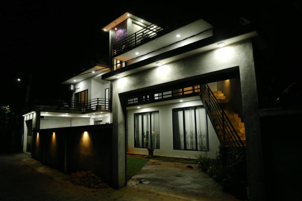 a lit up building at night with its lights on at Danu Homestay Kandy in Kandy