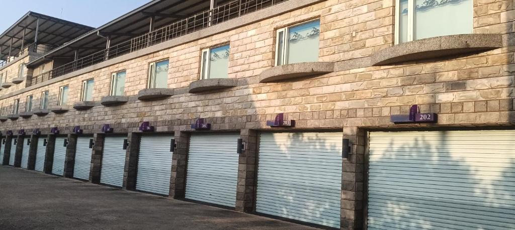 a row of garage doors on a brick building at Yue Xin Motel in Miaoli