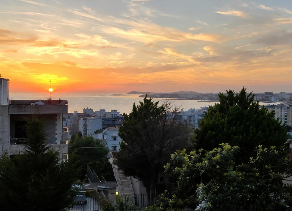 a view of a city with a sunset in the background at Actium in Vlorë