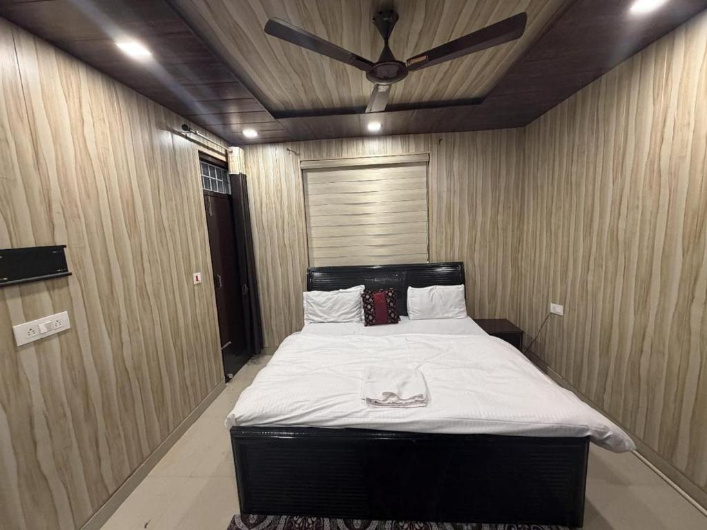 a bedroom with a bed with a ceiling fan at new Subh Apartment in Bhowāli
