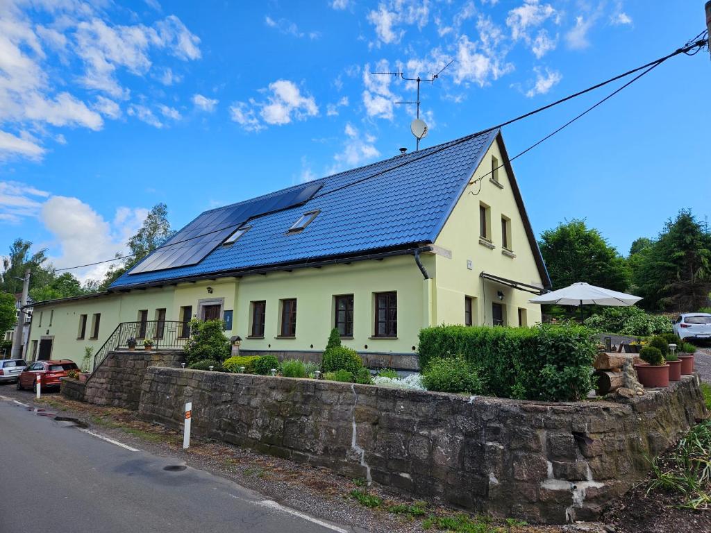 a house with a blue roof at Apartmán U Davida in Chvaleč