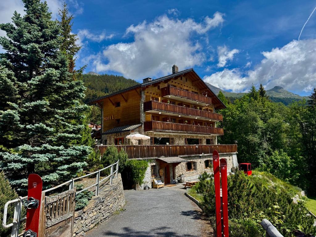 a large wooden building in the middle of a forest at Colorado Riders Chalet in Crans-Montana