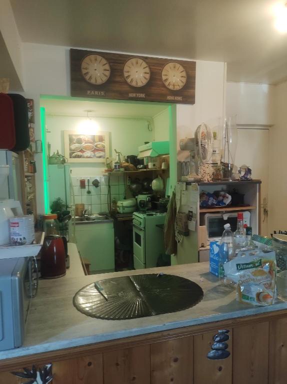a kitchen with a counter with a clock on the wall at Fab's Home in Oust