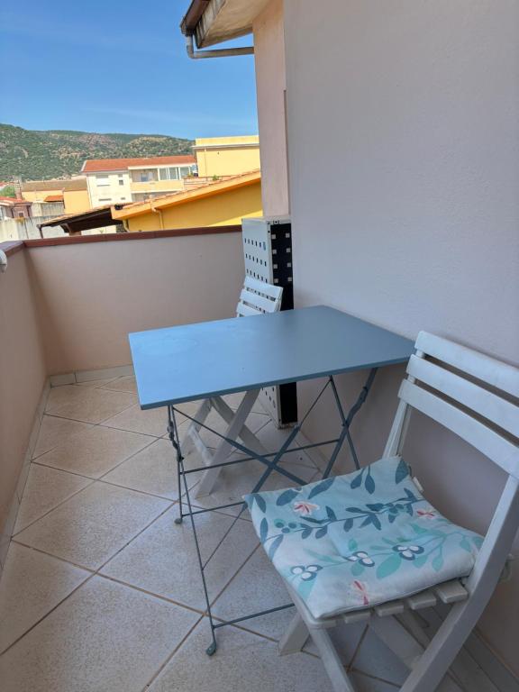 a blue table and a chair on a balcony at Comfort Home in Capoterra
