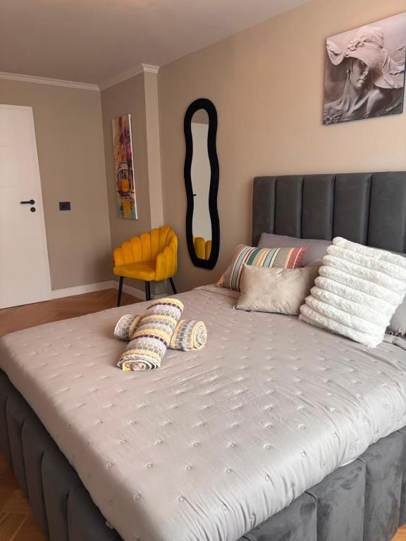 a large bed in a bedroom with a large headboard at GZP Residence Lugoj 13 in Lugoj