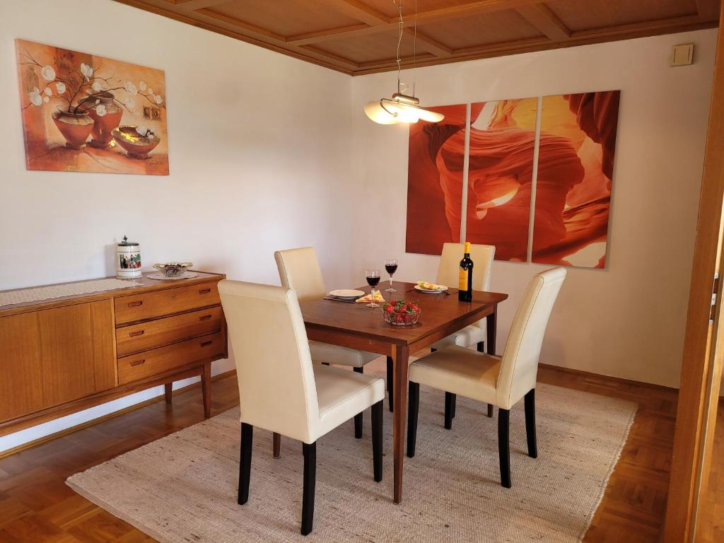 a dining room with a wooden table and chairs at Ferienwohung Lederle in Weiler-Simmerberg