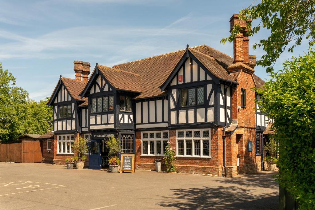 an old black and white building in a parking lot at The Mayflower in Lymington