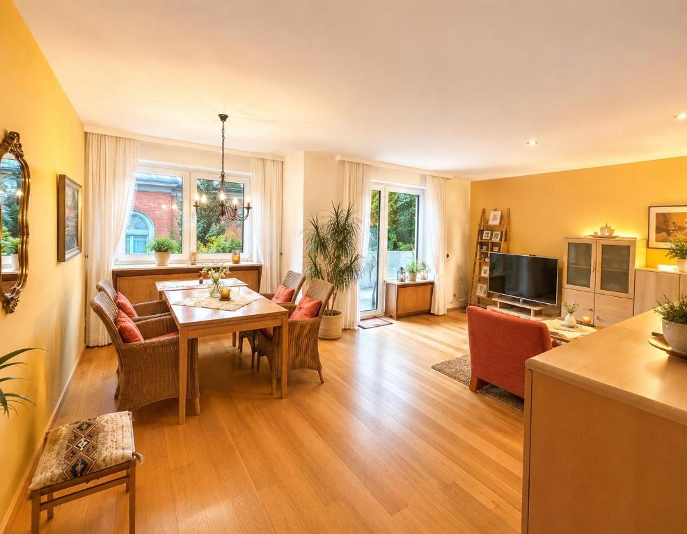 a living room with a table and chairs and a television at Gemütliche und Zentrumsnahe Wohnung in Goslar in Goslar