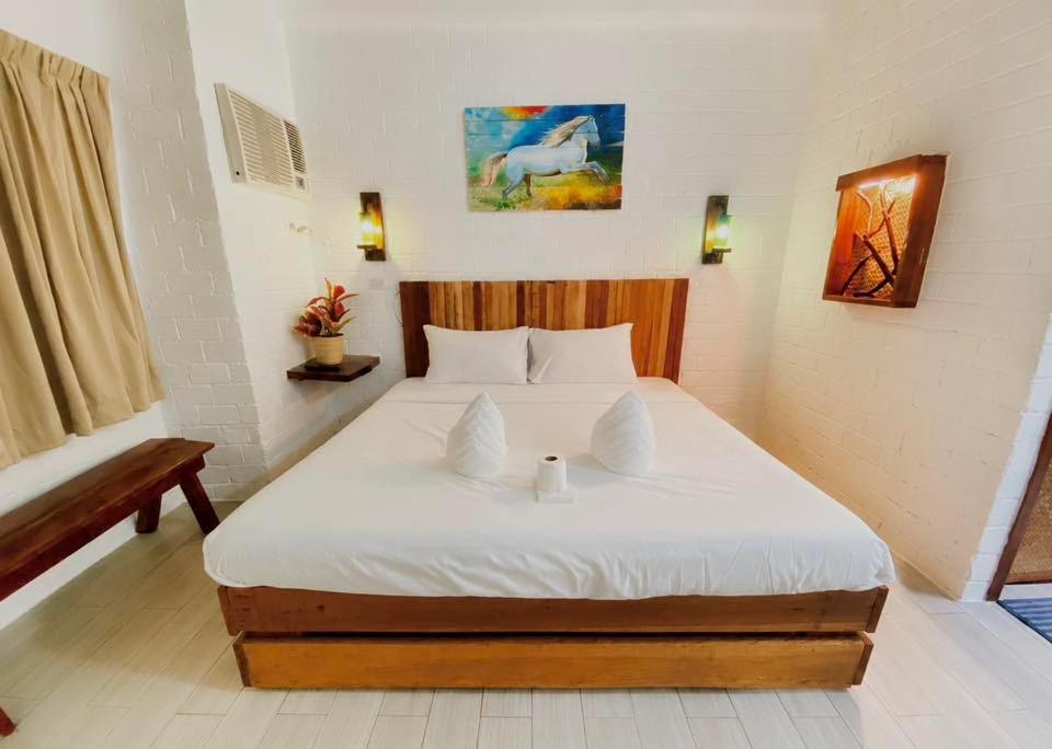 a bedroom with a large white bed in a room at Alona Marga in Panglao Island