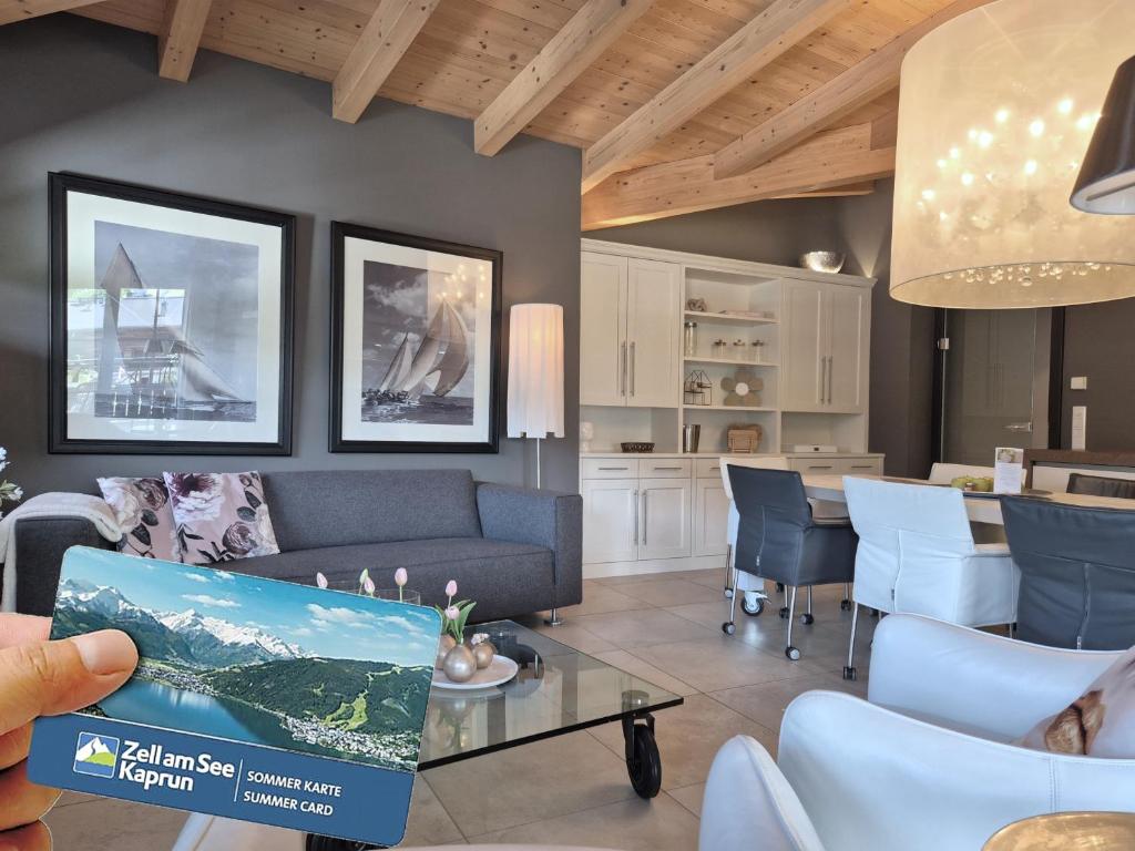 a living room with a couch and a table at Peak View Penthouse Kaprun in Kaprun