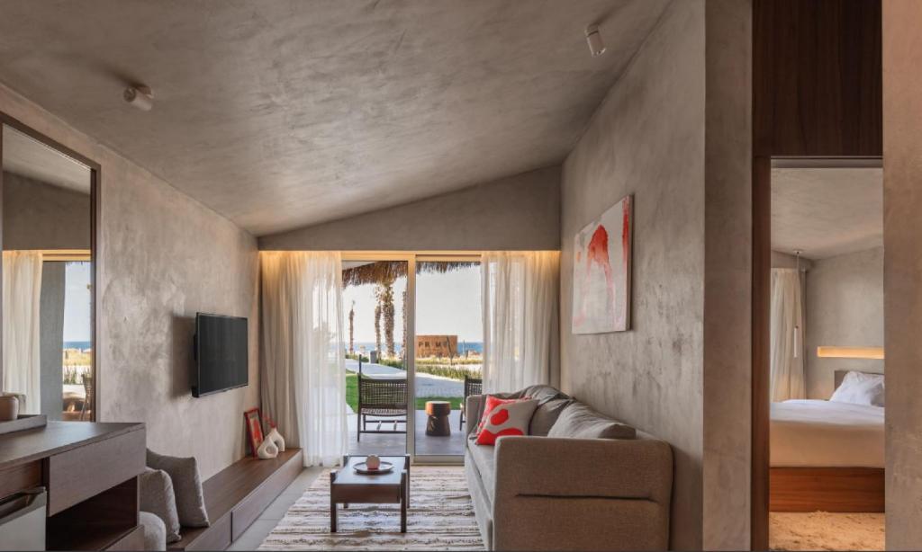 a living room with a couch and a bedroom at LYV Boutique Cabana in Marsa Matruh